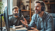 © ЮРИЙ ПОЗДНИКОВ - Two content creators recording audio podcast using professional microphone