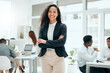 © KayExam/peopleimages.com - Happy, business woman and portrait with arms crossed and confidence from web writer at agency. Creative, smile and African employee ready for press, reporter and journalism work in office with staff