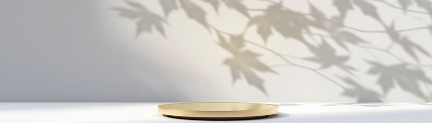 Gold empty circular podium with soft leaf shadows on a light background. Product display background with copy space