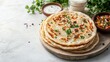 © atipong - Indian traditional Hot Onion Paratha with yogurt. Indian onion stuffed Flatbread. also known as Pyaz ke parathe in Hindi. over a light background with copy space.