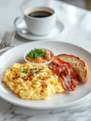 A delicious breakfast plate with scrambled eggs, bacon, toast, and a side of fruit.