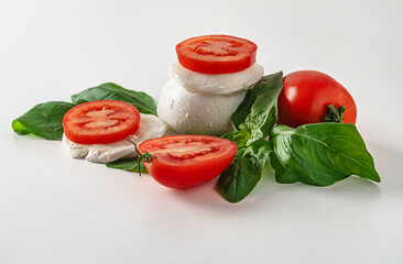 fresh mozzarella, tomatoes and basil leaves on a white surface caprese salad concept