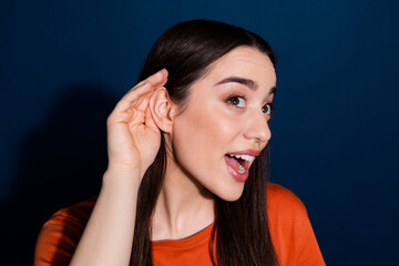 Canvas Print - Photo of funny cute adorable woman wear orange trendy clothes listen news isolated on dark blue color background