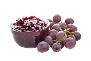 Closeup of jar of grape jam with a bunch of fresh grapes isolated on white transparent background. Concept of homemade preserves and fruit