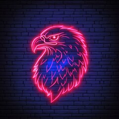 Wall Mural - Neon eagle head sign on a brick wall.