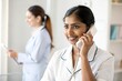 © N7 - Indian Reception Nurse Assisting Patient via Phone