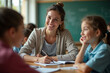 © Chen - a girl sits at a desk with her teacher and her teacher
