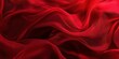 © Nice Seven - Luxurious red silk fabric background with flowing black shadows, creating a rich and elegant texture perfect for high-end product designs, fashion visuals, or luxury-themed presentations that evoke so