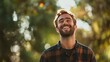 © Napasnan - A man in casual clothing, captured mid-laugh in a park setting, natural light enhancing his joyful expression