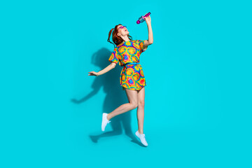 Full length photo of lovely young lady singing karaoke mic dressed stylish colorful garment isolated on cyan color background