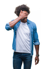 Wall Mural - Afro american man over isolated background smiling and laughing with hand on face covering eyes for surprise. Blind concept.