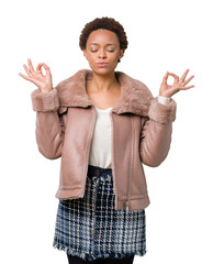 Young african american woman wearing winter coat over isolated background relax and smiling with eyes closed doing meditation gesture with fingers. Yoga concept.