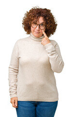 Beautiful middle ager senior woman wearing turtleneck sweater and glasses over isolated background Pointing to the eye watching you gesture, suspicious expression