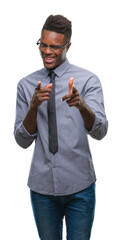 Wall Mural - Young african american business man over isolated background pointing fingers to camera with happy and funny face. Good energy and vibes.