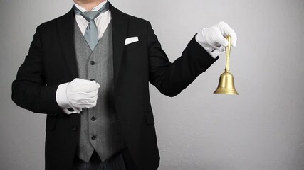 Wall Mural - Butler or Hotel Concierge in Formal Suit Ringing Gold Bell. Concept of Ring for Service.