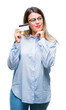 © Krakenimages.com - Young beautiful business woman holding credit card over isolated background serious face thinking about question, very confused idea