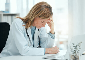 Doctor, stress and headache at laptop for mistake, clinical error and depression in office. Healthcare, mature cardiologist and anxiety in practice for misdiagnosis, patient loss or tension in career