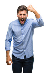 Wall Mural - Young handsome man over isolated background angry and mad raising fist frustrated and furious while shouting with anger. Rage and aggressive concept.