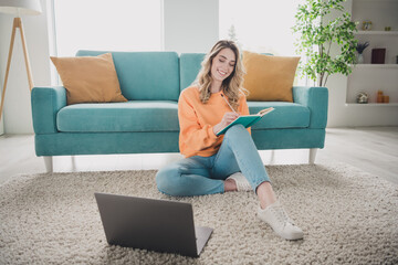 Wall Mural - Full length photo of nice cheerful girl sit floor netbook write notebook dressed orange garment spend pastime spacious house indoors room