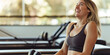 © Purple_Lamp - Smiling Woman in Activewear Enjoying Workout at Modern Fitness Studio