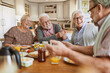 © Marko Geber - Diverse senior friends having breakfast together at home