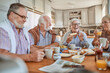© Marko Geber - Diverse senior friends having breakfast together at home