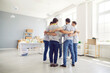 © Studio Romantic - A group of men hugging each other stand in a circle in the center of the room. Concept of solidarity and mutual support, teamwork. General desire for cooperation and assistance, volunteers