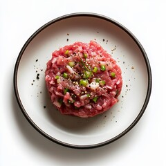 Delicious elegant beef tartare with fresh herbs and seasoning on minimalist plate