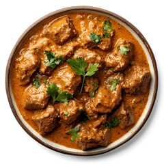 Wall Mural - Delicious indian beef curry garnished with fresh cilantro in a ceramic bowl