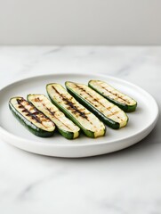 Wall Mural - Grilled zucchini slices arranged on a white plate.