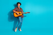 © deagreez - Full size photo of nice young man sing play guitar wear shirt isolated on teal color background