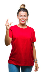 Young beautiful woman over isolated background smiling and confident gesturing with hand doing size sign with fingers while looking and the camera. Measure concept.