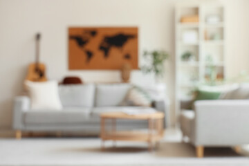 Wall Mural - Blurred view of living room with sofa, table and world map on white wall