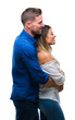 © Krakenimages.com - Young couple in love over isolated background looking to side, relax profile pose with natural face with confident smile.