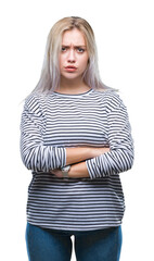 Wall Mural - Young blonde woman over isolated background skeptic and nervous, disapproving expression on face with crossed arms. Negative person.