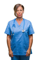Wall Mural - middle age senior nurse doctor woman over isolated background with serious expression on face. simpl
