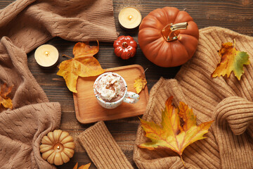 Poster - Autumn composition with cup of cocoa, sweaters and candles on wooden background