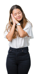 Wall Mural - Young beautiful brunette business woman over isolated background sleeping tired dreaming and posing with hands together while smiling with closed eyes.