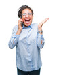 © Krakenimages.com - Young braided hair african american business girl showing calling using smartphone over isolated background very happy and excited, winner expression celebrating victory screaming with big smile