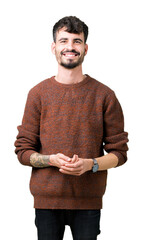 Young handsome man wearing winter sweater over isolated background Hands together and fingers crossed smiling relaxed and cheerful. Success and optimistic