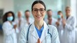 © Vilaysack - A smiling female doctor wearing glasses and a stethoscope, standing confidently in front of a team of healthcare professionals, showcasing teamwork and leadership.