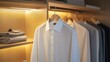 © bismillah_bd - White formal shirt hanging in a wooden closet