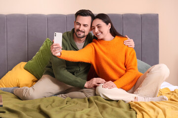 Poster - Young couple taking selfie in bedroom on autumn day