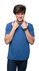 Wall Mural - Young handsome man wearing blue t-shirt over isolated background Smiling with open mouth, fingers pointing and forcing cheerful smile