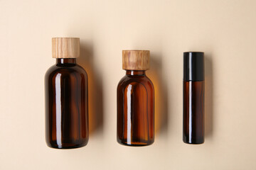 Wall Mural - Essential oils in bottles on beige background, flat lay