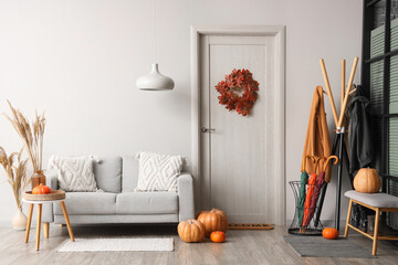 Poster - Door mat with and autumn pumpkins and umbrellas near white wall in hallway