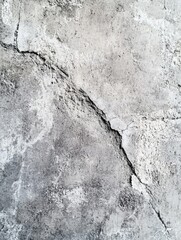 Wall Mural - A grey wall with cracks and holes. The wall is made of concrete and has a rough texture