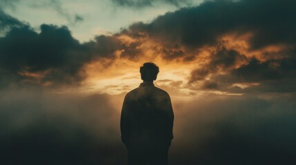 Wall Mural - Facing my Faith. Silhouette of a man standing in front of the sky with clouds.