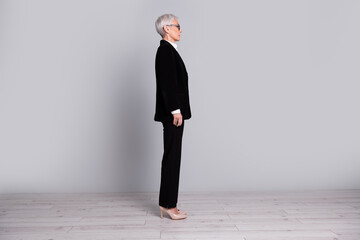 Wall Mural - Full length profile photo of charming successful retired lady wear black suit isolated on grey color background