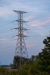 power lines with the sunset by a highway